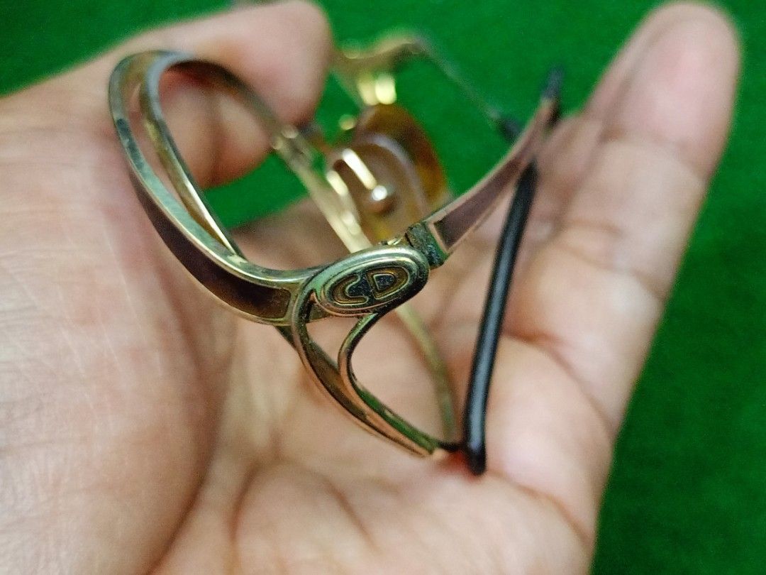Vintage Christian Dior Eyeglass Frames Gold CD Logo (Category: Sunglasses & Eyewear) located in Bacoor. Submitted by bibelot03 (Listing ID 1467761370, Image 2). Description: - Gold-tone/Gold Plated metal frames with tortoiseshell nose pads and temple tips - Classic double bridge architecture - Distinctive CD logo badge on temple hinges - Sleek black temple arms - Rx-ready: suitable for prescription or tinted lenses.