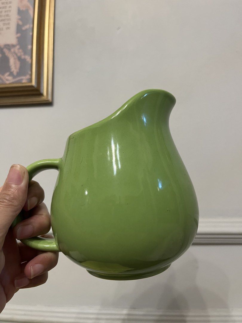 Vintage lime-green or chartreuse ceramic creamer pitcher (Category: Pitchers & Dispensers) located in Quezon City. Submitted by metamerchant (Listing ID 1467740018, Image 1). Description: - Vibrant bright green ceramic pitcher with a glossy glaze finish - Features a sturdy handle and wide pouring spout for easy serving - Stable round flat base with a clean interior - Versatile everyday piece ideal for water, juice, or table flowers - Condition: B