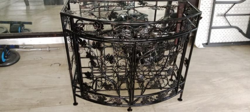Vintage Wrought Iron Wine Rack Console Table / Bar Cabinet (Category: Shelves, Cabinets & Racks) located in Taytay. Submitted by airamgarcia (Listing ID 1467692785, Image 1). Description: Description: Elegant half-moon / curved wrought iron console bar table featuring intricate grapevine leaf metalwork. Includes a top glass surface insert and lower built-in slots to securely store wine bottles and wine glasses. Perfect as a home bar accent table,