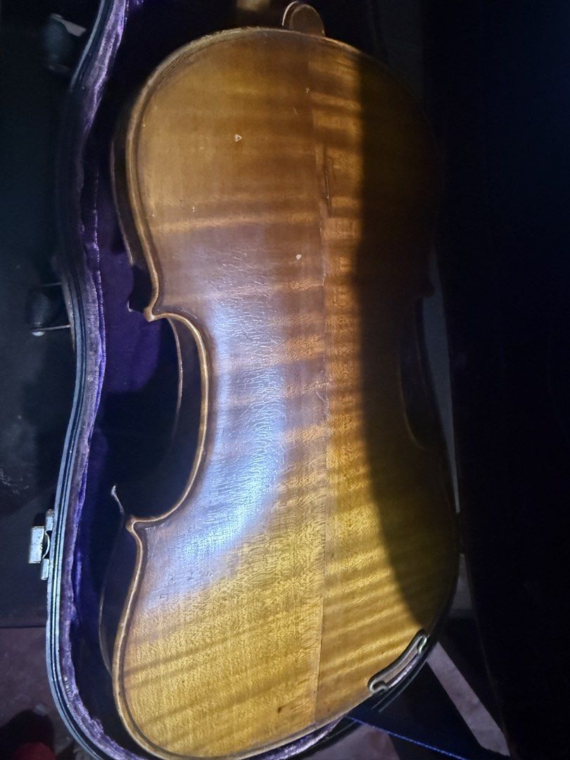 Violin as is (Category: Musical Instruments) located in Manila. Submitted by happytiger-4660 (Listing ID 1467605856, Image 3). Description: - Wooden acoustic violin with standard 4-string setup, bridge, and tailpiece installed - Includes a sturdy fitted hard carrying case with a plush purple interior lining - Cosmetic wear: visible varnish fading near the upper left bout - Structural note: cracks separating the top plate and ribs near the neck jo