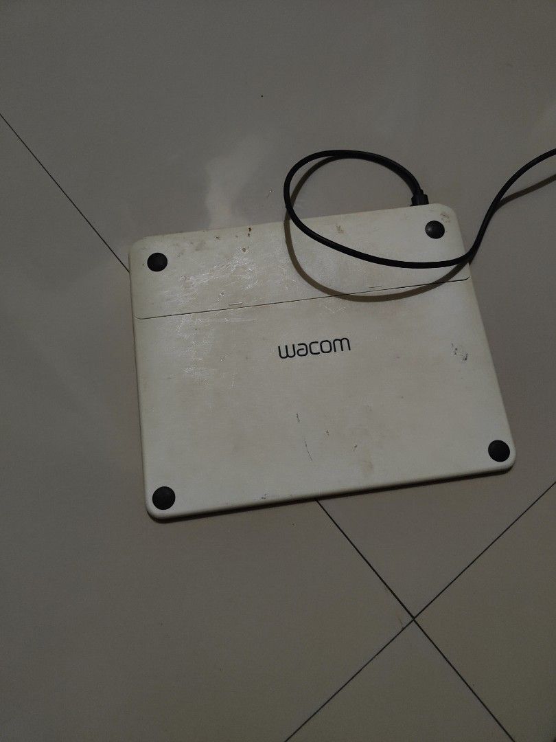 Wacom Drawing Tablet with USB Cable (Category: Laptops & Notebooks) located in Manila. Submitted by jojemar890 (Listing ID 1467699755, Image 1). Description: - Model: Wacom Drawing Tablet (Black & White) - Connectivity: Attached USB cable with standard connector for direct plug-and-play - Condition: Active drawing surface shows minor signs of use - Features: Two physical buttons at the top for quick access - Stability: Equipped with rubber feet o
