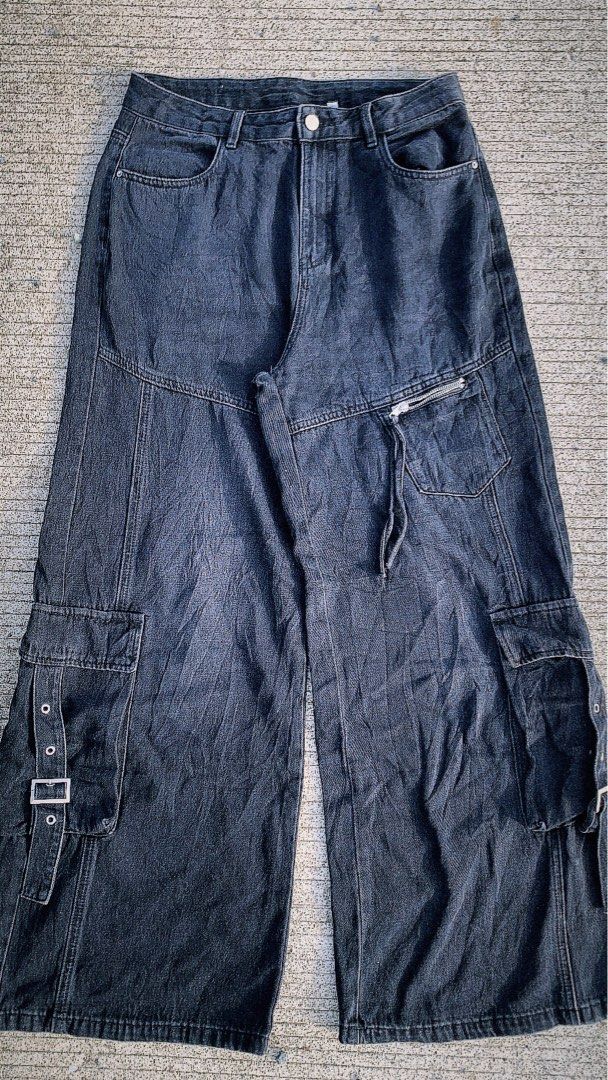 Washed Black Cargo Jeans with Multi Pockets and Buckle (Category: Jeans) located in Iloilo. Submitted by johnpullan30303 (Listing ID 1467610894, Image 1). Description: - Color/Wash: Washed Black - Fit: Relaxed, straight wide leg with structured paneling - Rise: Mid-rise with standard belt loops - Storage: Multiple pockets featuring secure zippered and buckled compartments - Style: Trendy streetwear aesthetic.
