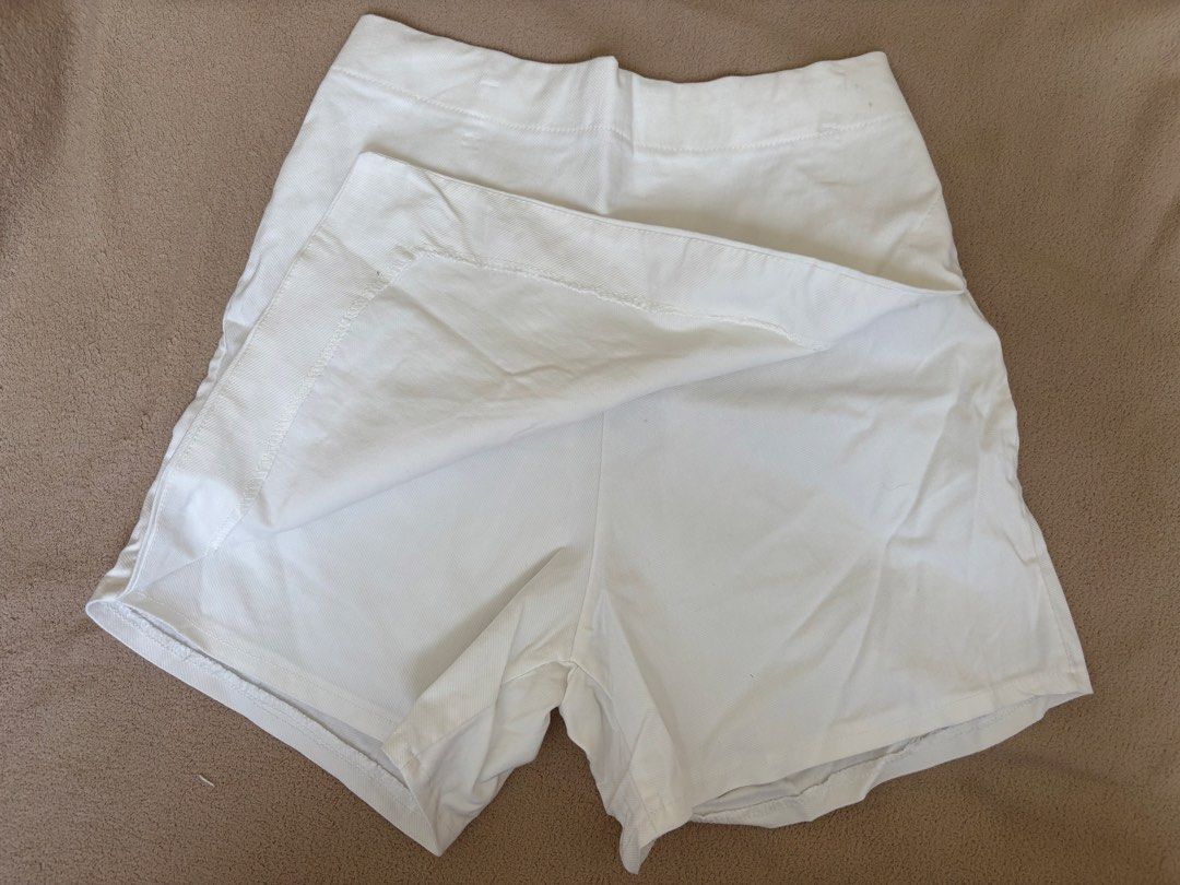 White asymmetrical wrap-style mini short (Category: Shorts) located in Pasig City. Submitted by llovedbyliv (Listing ID 1467632866, Image 2). Description: Waist - 25-28in (stretchable) Length - 13in No issues.