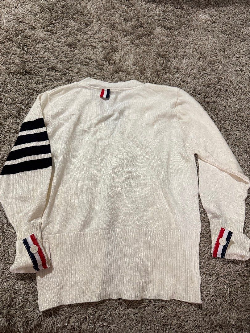 White Cardigan with Stripe Detail (Category: Coats, Jackets and Outerwear) located in Caloocan City. Submitted by newcrystal_3b43ba (Listing ID 1467756774, Image 3). Description: - Style: White knit cardigan with V-neck and front button closure - Design: Signature red, white, and blue grosgrain stripe trim along the placket and cuffs - Detail: Classic 4-bar stripes on the left upper sleeve - Fit & Feel: Soft, comfortable knit material with ribbed