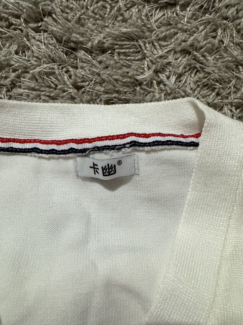 White Cardigan with Stripe Detail (Category: Coats, Jackets and Outerwear) located in Caloocan City. Submitted by newcrystal_3b43ba (Listing ID 1467756774, Image 2). Description: - Style: White knit cardigan with V-neck and front button closure - Design: Signature red, white, and blue grosgrain stripe trim along the placket and cuffs - Detail: Classic 4-bar stripes on the left upper sleeve - Fit & Feel: Soft, comfortable knit material with ribbed