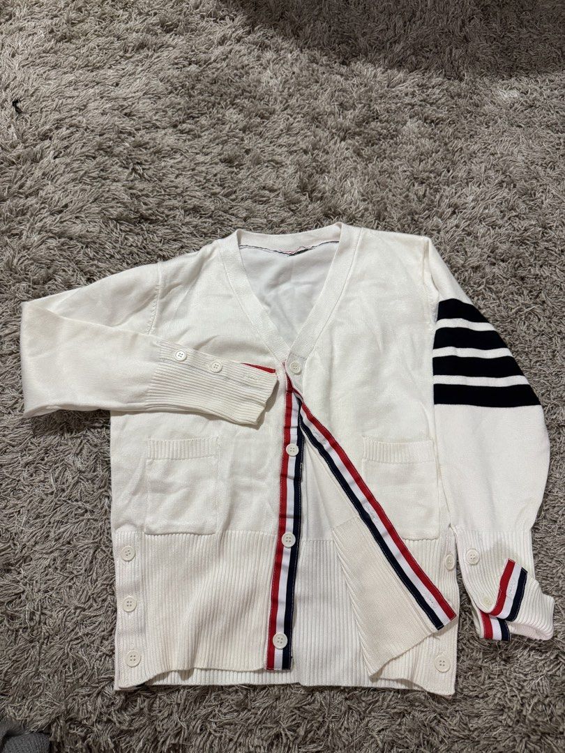 White Cardigan with Stripe Detail (Category: Coats, Jackets and Outerwear) located in Caloocan City. Submitted by newcrystal_3b43ba (Listing ID 1467756774, Image 1). Description: - Style: White knit cardigan with V-neck and front button closure - Design: Signature red, white, and blue grosgrain stripe trim along the placket and cuffs - Detail: Classic 4-bar stripes on the left upper sleeve - Fit & Feel: Soft, comfortable knit material with ribbed