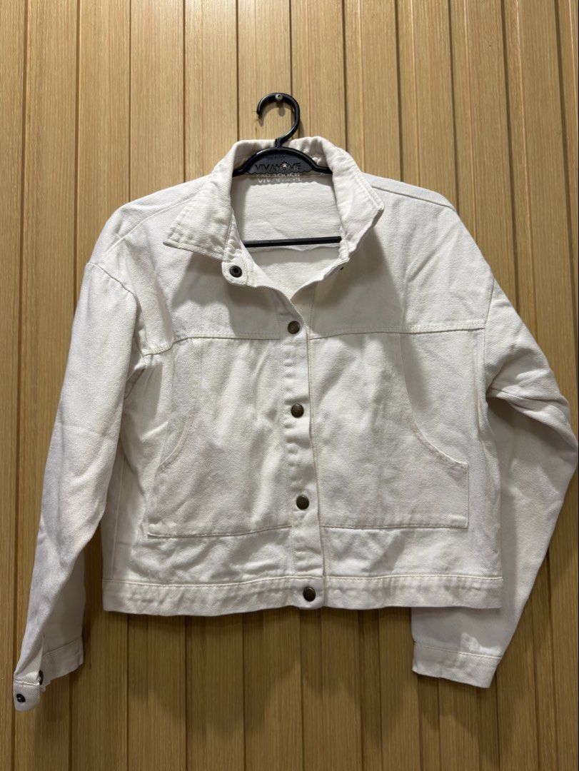 White denim jacket with front pockets and buttons (Category: Coats, Jackets and Outerwear) located in Bacoor. Submitted by preloved_with_love_ (Listing ID 1467610360, Image 1). Description: - Style: Trendy cropped white denim jacket - Material: Structured, high-quality cotton - Details: Classic collar, dark metallic button-down front, button cuffs - Pockets: Two large front utility pockets near the hem - Fit & Versatility: Easy everyday layering 