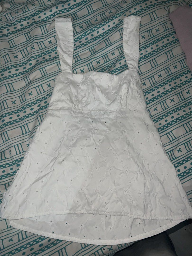 White Eyelet Tie-Back Tank Top Blouse (Category: Sleeveless) located in Marikina City. Submitted by ash_2 (Listing ID 1467695963, Image 1). Description: - Color: White - Design: All-over eyelet embroidery with a flattering square neckline - Details: Open back with double tie-back closures and a flowy peplum hem - Fabric: Lightweight and breathable, ideal for warm days - Condition: Good as new.