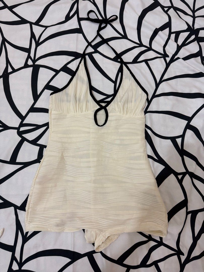 White Halter Neck Crinkle Romper with Black Trim (Category: Bikinis & Swimsuits) located in Bulacan. Submitted by alshopie (Listing ID 1467638443, Image 2). Description: - Style: One-piece swimsuit romper with attached short shorts - Design: White crinkle-textured fabric with contrasting black piping and chest cutout - Straps: Adjustable halter ties at the back - Material: Stretchy, comfortable fabric - Condition: Clean, excellent, and ready to w