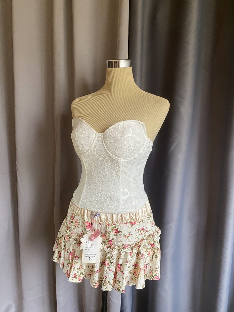 Lioness White Lace Strapless Corset Bustier Top (Category: Sleeveless) located in Cagayan de Oro. Submitted by curated_closetph (Listing ID 1467765713, Image 2). Description: — Size : XS - S — Color: White — Sheer floral lace overlay for a romantic look — Strapless sweetheart neckline — Molded underwire cups for support and shaping — Internal boning for a cinched waist — Adjustable multi-row hook-and-eye back closure — Straight hemline for versat