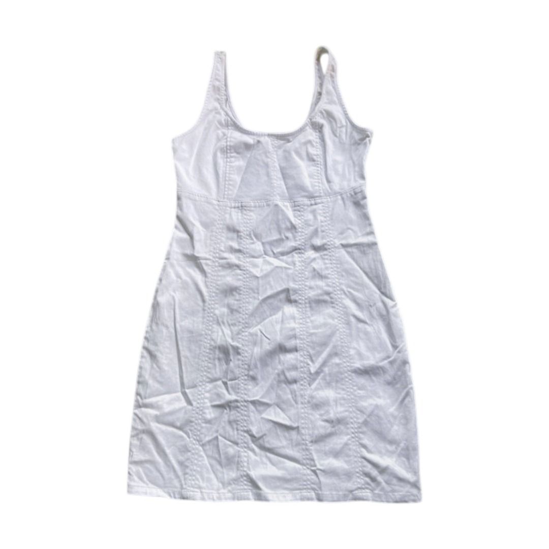 White mini dress (Category: Dresses) located in Rizal. Submitted by sheeraay (Listing ID 1467657588, Image 1). Description: - Color: White - Style: Sleeveless tank dress with scoop neckline - Fit: Fitted with vertical paneled seams for a flattering shape - Length: Short, hits above the knee - Material: Stretchy cotton blend, unlined - Versatile: Easy pullover style, perfect to pair with sneakers or sandals for warm days.