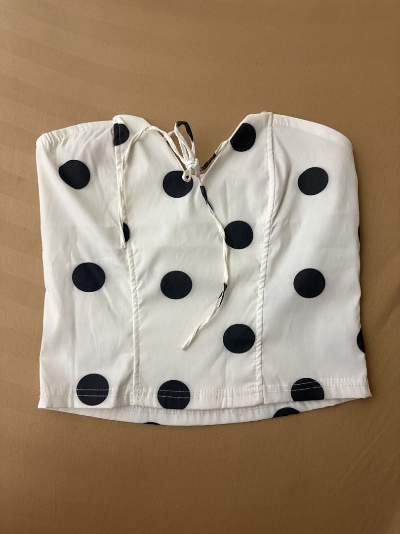 White Polka Dot Tube Top (Category: Sleeveless) located in Pasay City. Submitted by faye_xoxo (Listing ID 1467704096, Image 2). Description: - bought from Tiktok Shop - Good as new; only used once last month - NO FLAWS - White tube top featuring large black polka dots all over -Cropped fit .