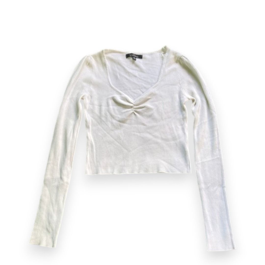 White ribbed long sleeve top with ruched neckline (Category: Longsleeves) located in Rizal. Submitted by sheeraay (Listing ID 1467665686, Image 1). Description: - Color: White - Material: Soft ribbed knit - Fit: Slim fit - Design: Deep V-neckline with front gathered ruched detail - Sleeves: Long sleeves.
