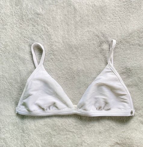 White Ribbed Triangle Bikini Top (Category: Bikinis & Swimsuits) located in Rizal. Submitted by sheeraay (Listing ID 1467648134, Image 2). Description: - Color: White - Style: Classic triangle cups with thin shoulder straps - Material: Textured ribbed fabric.