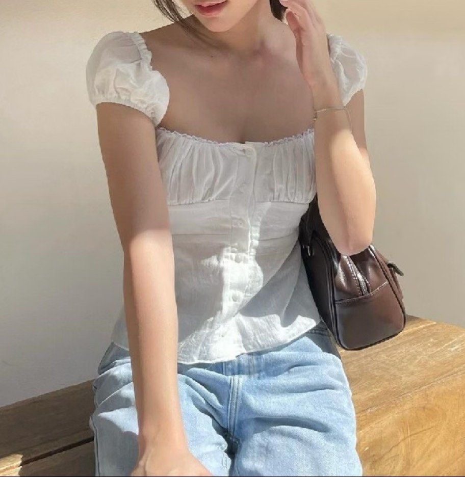 White Square Neck Milkmaid Puff Sleeve Button-Up Blouse (Category: Blouses) located in Davao. Submitted by taegikook (Listing ID 1467674737, Image 1). Description: - Lightly used but still in good condition 😊 - Best fits size XS-S (pls see measurements in last pic) - Style: Square neck milkmaid top with short puff sleeves - Details: Chic gathered bust and functional front button-up closure - Material: Soft, lightweight, and breathable cotton - R