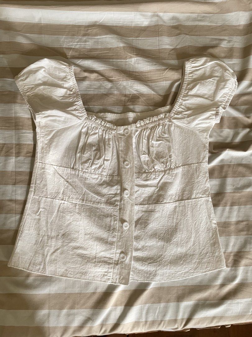 White Square Neck Milkmaid Puff Sleeve Button-Up Blouse (Category: Blouses) located in Davao. Submitted by taegikook (Listing ID 1467674737, Image 2). Description: - Lightly used but still in good condition 😊 - Best fits size XS-S (pls see measurements in last pic) - Style: Square neck milkmaid top with short puff sleeves - Details: Chic gathered bust and functional front button-up closure - Material: Soft, lightweight, and breathable cotton - R