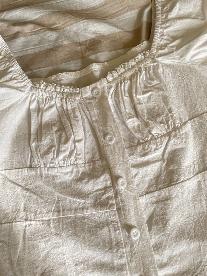 White Square Neck Milkmaid Puff Sleeve Button-Up Blouse (Category: Blouses) located in Davao. Submitted by taegikook (Listing ID 1467674737, Image 3). Description: - Lightly used but still in good condition 😊 - Best fits size XS-S (pls see measurements in last pic) - Style: Square neck milkmaid top with short puff sleeves - Details: Chic gathered bust and functional front button-up closure - Material: Soft, lightweight, and breathable cotton - R