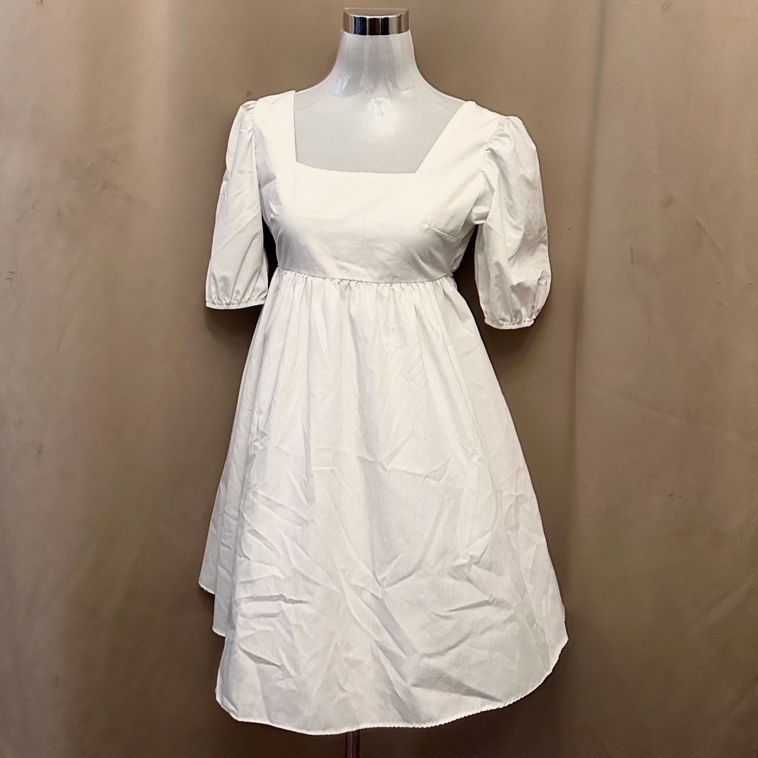White Square Neck Puff Sleeve Open Back Dress (Category: Dresses) located in Manila. Submitted by jade_preloved19 (Listing ID 1467671012, Image 1). Description: - Color: White - Style: Mini dress with square neckline and gathered puff sleeves - Fit: High waistline with a flattering flared skirt - Back Detail: Open back with two adjustable thin tie straps - Material: Lightweight and breathable cotton - Best For: Casual outings, weekend dates, and 
