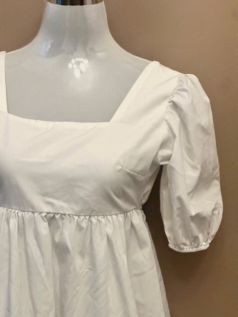 White Square Neck Puff Sleeve Open Back Dress (Category: Dresses) located in Manila. Submitted by jade_preloved19 (Listing ID 1467671012, Image 2). Description: - Color: White - Style: Mini dress with square neckline and gathered puff sleeves - Fit: High waistline with a flattering flared skirt - Back Detail: Open back with two adjustable thin tie straps - Material: Lightweight and breathable cotton - Best For: Casual outings, weekend dates, and 