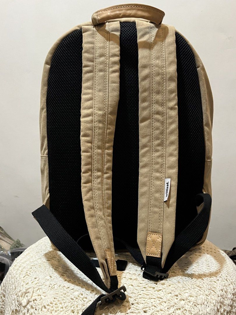 Willicot World Famous Travelers Canvas Backpack (Category: Backpacks) located in Bacolod City. Submitted by vintage_vogue6100 (Listing ID 1467760575, Image 3). Description: - Brand: Willicot - Material: Tan canvas - Dimensions: 40cm (H) x 29cm (L) x 13cm (W) - Exterior: Front zippered pocket with leather pull tab and side strap hook details - Comfort: Padded black mesh back straps - Interior: Blue and white striped lining with a dedicated black p