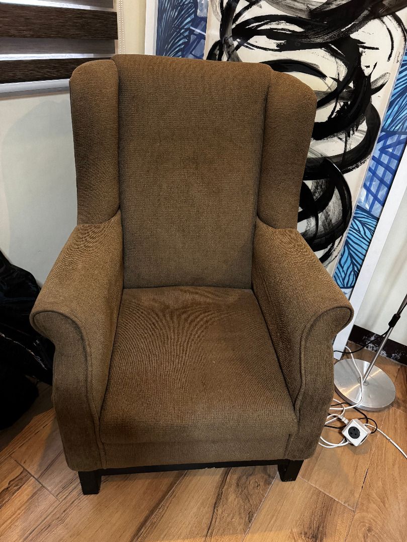 Wingback Lounge Chair (Category: Chairs) located in Marilao. Submitted by miguelsanti (Listing ID 1467634946, Image 2). Description: - Style: Classic brown wingback armchair - Material: Textured woven fabric - Features: High backrest and sturdy dark wooden legs - Size: Standard single-seater - Ideal for: Living room accent chair or reading corner - Condition: Great Can be delivered to you if buyer from Metro Manila, outside NCR buyer will shoulde
