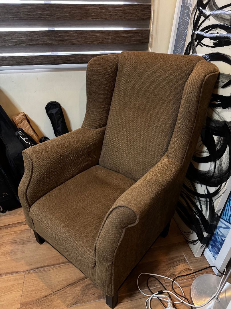 Wingback Lounge Chair (Category: Chairs) located in Marilao. Submitted by miguelsanti (Listing ID 1467634946, Image 3). Description: - Style: Classic brown wingback armchair - Material: Textured woven fabric - Features: High backrest and sturdy dark wooden legs - Size: Standard single-seater - Ideal for: Living room accent chair or reading corner - Condition: Great Can be delivered to you if buyer from Metro Manila, outside NCR buyer will shoulde