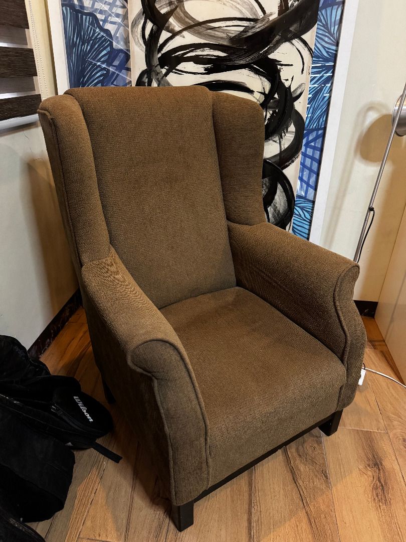 Wingback Lounge Chair (Category: Chairs) located in Marilao. Submitted by miguelsanti (Listing ID 1467634946, Image 1). Description: - Style: Classic brown wingback armchair - Material: Textured woven fabric - Features: High backrest and sturdy dark wooden legs - Size: Standard single-seater - Ideal for: Living room accent chair or reading corner - Condition: Great Can be delivered to you if buyer from Metro Manila, outside NCR buyer will shoulde