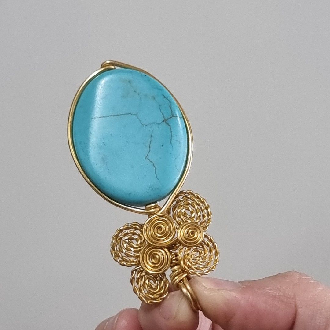 Wire Wrapped Turquoise Oval Pendant (Category: Necklaces) located in Pasig City. Submitted by lesmitch (Listing ID 1467644859, Image 3). Description: - Handmade wire-wrapped pendant with a vibrant blue oval turquoise stone - Intricate gold-toned wire work featuring a charming cluster of spiral roses - Neatly finished artisan detailing on the back frame - Secure top loop ready for any chain or cord - Perfect unique accessory or gift for any occasi