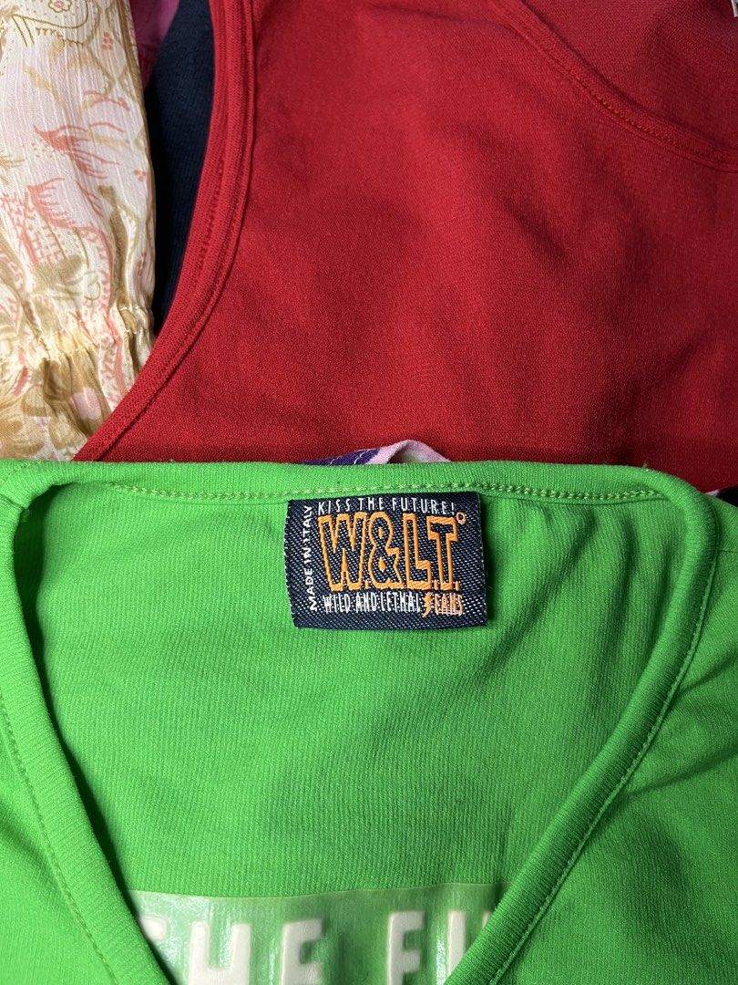 W&LT Wild and Lethal Trash Green Top (Category: Shirts) located in Catbalogan. Submitted by yellfindss (Listing ID 1467812057, Image 3). Description: - Brand: W&LT Wild and Lethal Trash (Made in Italy) - Color: Bright green - Style: 3/4 sleeve, V-neck, comfortable cotton fit - Details: 'Kiss The Future' debossed graphic on the back, chest lettering - Accent: Small embroidered lightning bolt logo on the front.