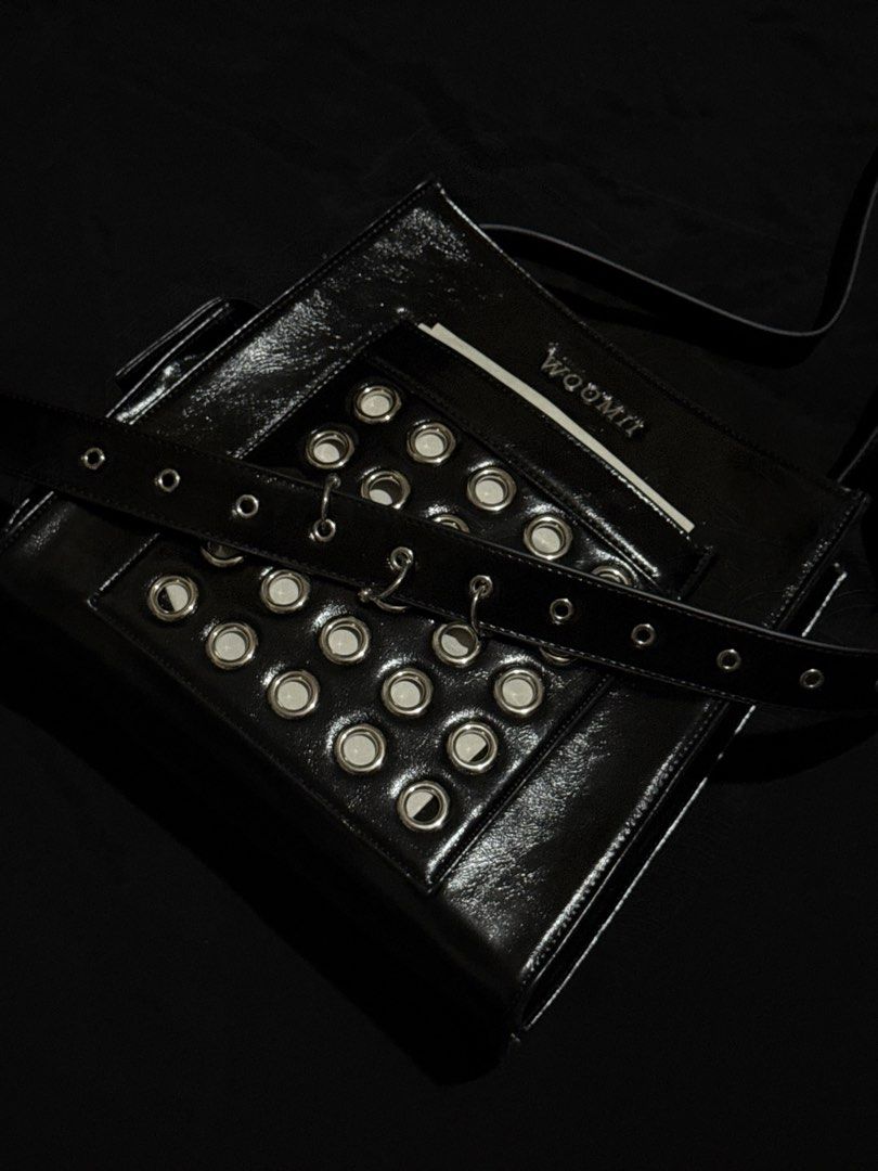 WOOMII ELI BLACK EYELET BAG (Category: Luxury Bags & Wallets) located in Guiguinto. Submitted by rlyrc_ (Listing ID 1467821636, Image 2). Description: The bag that carries it all with attitude. ELLI’s hardware details : eyelets and piercings add edge to her roomy, functional shape. Strong, bold, and made to fit more than you think. Wear crossbody for everyday cool or tighten strap to carry her over your shoulders as a handbag. (Price is negotiabl