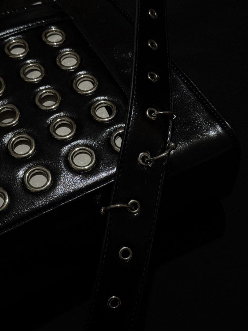 WOOMII ELI BLACK EYELET BAG (Category: Luxury Bags & Wallets) located in Guiguinto. Submitted by rlyrc_ (Listing ID 1467821636, Image 3). Description: The bag that carries it all with attitude. ELLI’s hardware details : eyelets and piercings add edge to her roomy, functional shape. Strong, bold, and made to fit more than you think. Wear crossbody for everyday cool or tighten strap to carry her over your shoulders as a handbag. (Price is negotiabl