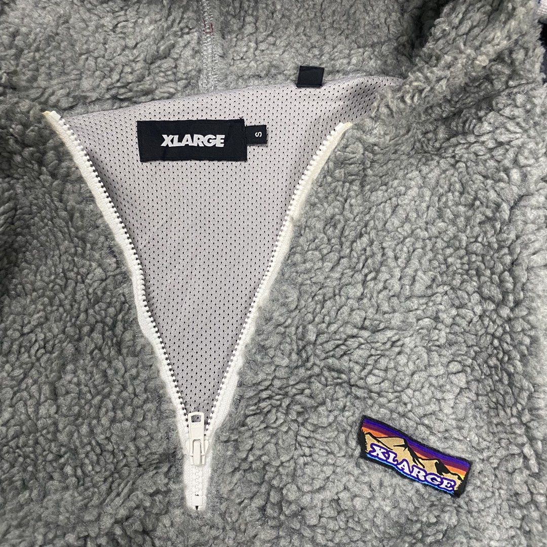 X large sherpa jacket quarter zip (Category: Coats, Jackets and Outerwear) located in Santa Maria. Submitted by saintarchive316 (Listing ID 1467836600, Image 2). Description: XLARGE Half Zip Boa Hoodie in grey, featuring a long-pile fleece (boa) material, a front half-zipper, a left-chest brand patch, and blue-and-white striped ribbed cuffs and hem.