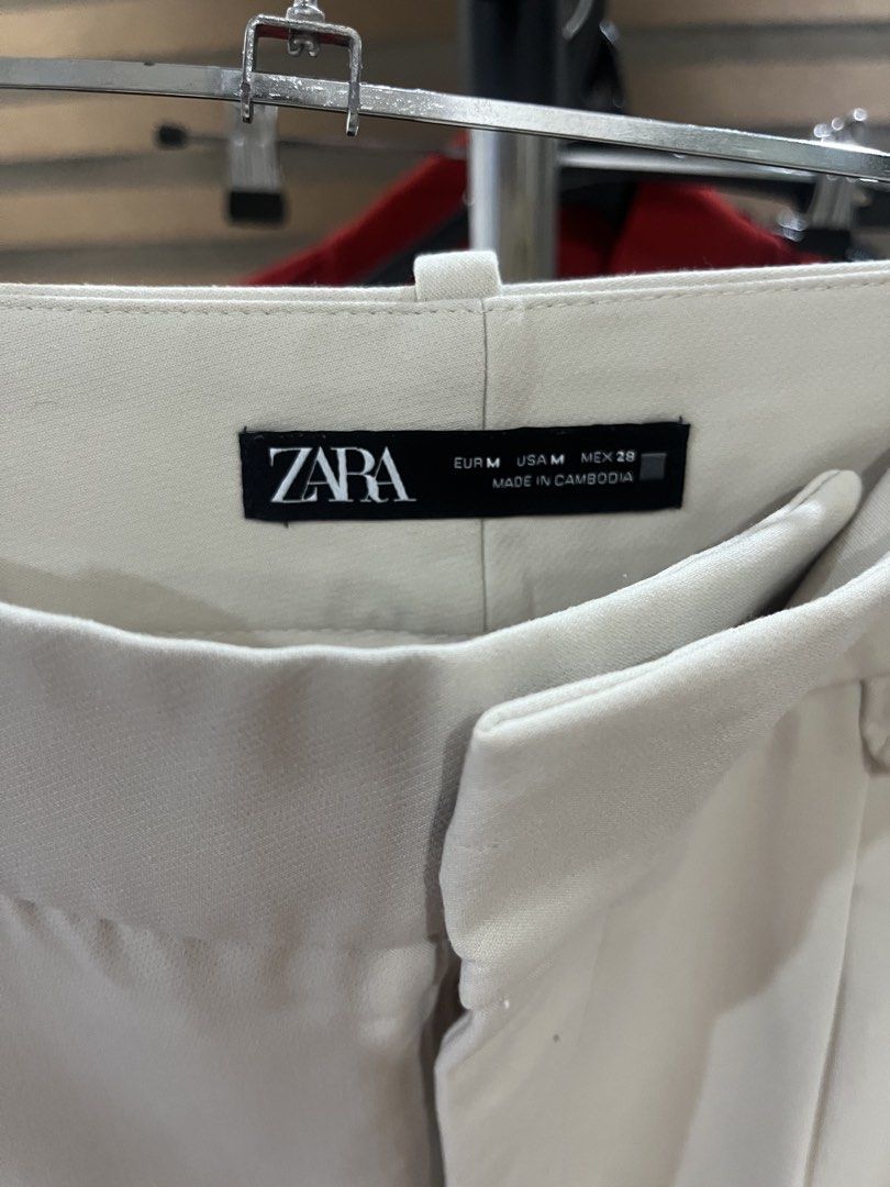 Zara Beige Tailored Trousers Size M (Category: Trousers) located in Makati City. Submitted by grizzlybear95 (Listing ID 1467730119, Image 2). Description: - Brand: Zara - Size: M / MEX 28 - Color: Cream / Beige - Details: Front pleats, belt loops, functional side pockets, clean back design with welt pocket details - Fabric: Smooth finish with slight stretch - Style: Versatile neutral trousers, great for work or casual outings.