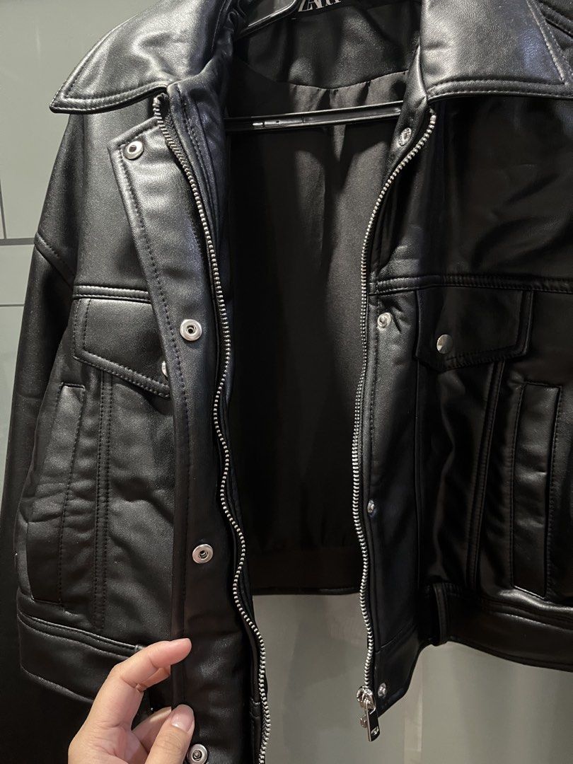 Zara Black Faux Leather Jacket (Category: Coats, Jackets and Outerwear) located in Makati City. Submitted by grizzlybear95 (Listing ID 1467733817, Image 3). Description: - Brand/Style: Zara black faux leather jacket - Fit: Cropped fit with collar - Closure: Front zipper and snap buttons - Pockets: Flap chest pockets and side pockets - Details: Zippers on the sleeves - Condition: Clean, worn a couple of times - Perfect for layering - Minimal chipp