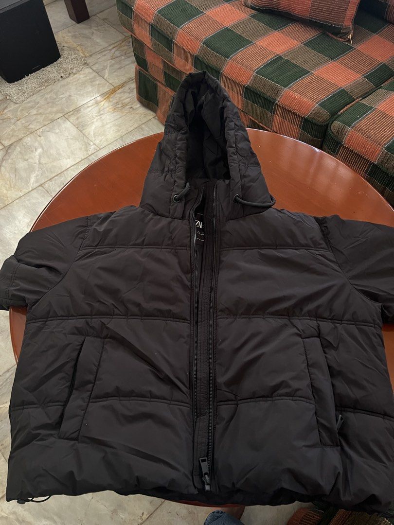 Zara Black Puffer Jacket with Hood (Category: Coats, Jackets and Outerwear) located in Cainta. Submitted by preloved_sale8 (Listing ID 1467629942, Image 2). Description: - Brand: Zara - Style: Puffer jacket in classic black - Size: L (best fit medium to large) - used once in Japan - in good condition (hnd namumuo) - Features: Full zip front, adjustable drawstring hood, quilted design, and two front pockets - Condition: Excellent, warm winter laye