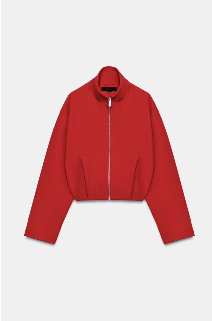 Zara High Collar Bomber Jacket (Category: Coats, Jackets and Outerwear) located in Quezon City. Submitted by justdeclutter2023 (Listing ID 1467716062, Image 1). Description: Bright red zip-up jacket from Zara. High standing collar, silver-tone front zipper with rectangular pull tab. Cropped length with structured seams and gathered hem in back. Long sleeves, relaxed shoulders. Heavy structured fabric. Clean minimal silhouette, vibrant pop of colo