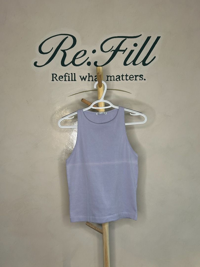 Zara Lilac Ribbed Tank Top Size M (Category: Sleeveless) located in Taguig. Submitted by re.wear.mnl (Listing ID 1467710009, Image 1). Description: - Brand: Zara - Color: Pastel Lilac - Size: Medium - Material: Ribbed knit with great stretch - Design: Classic scoop neckline and sleeveless cut - Versatility: Easy to style with denim, shorts, or skirts; great for warm weather or layering - Condition: Clean and ready to wear.