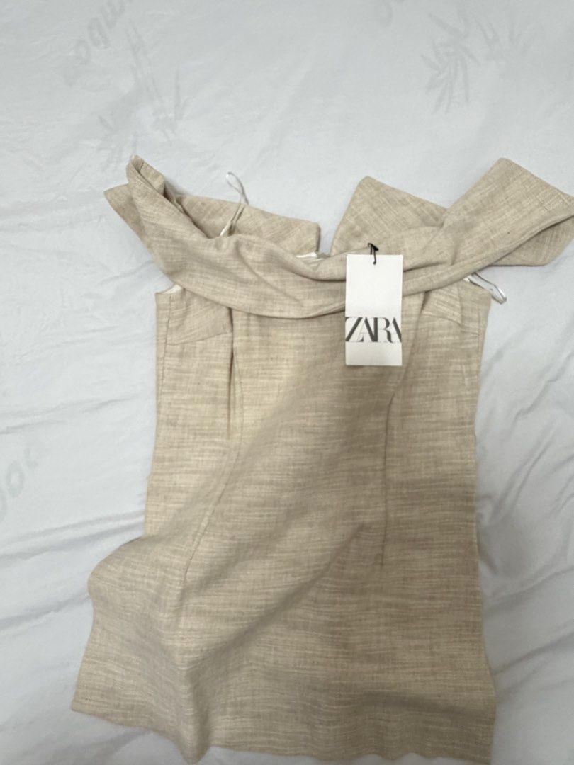 Zara Off-Shoulder Beige Dress (Category: Dresses) located in Santa Rosa. Submitted by decluttering_. (Listing ID 1467610454, Image 1). Description: - Brand: Zara - Style: Off-shoulder dress - Color: Neutral beige (goes with everything) - Size: S - Condition: Brand new with original tags attached, never worn - Details: Textured fabric with a structured body-hugging fit.