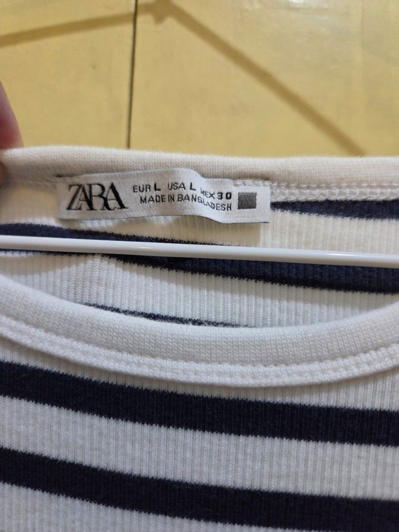 ZARA Striped Cap-Sleeve Top (Size Large) (Category: Blouses) located in Paranaque City. Submitted by mauandchelliedeclutters (Listing ID 1467783581, Image 3). Description: -authentic ZARA Striped Ribbed Top in Size Large - nautical style stripes in off-white and dark navy blue. -​Made from a soft, stretchy ribbed cotton-blend knit fabric. -Designed with a round crew neckline and flattering cap/cap-sleeve cut. ​Key Details & Features: ​Brand: ZARA