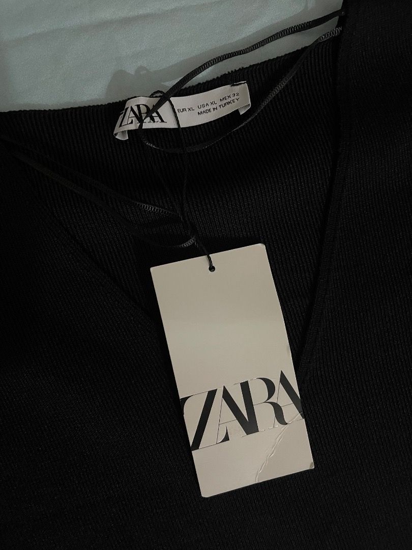 Zara Striped Knit Dress (Category: Dresses) located in Subic. Submitted by anything_lovely_under_the_sun (Listing ID 1467837719, Image 2). Description: - Brand: Zara - Condition: Brand new with original tags attached - Size: XL - Color/Design: Black and white striped upper body with a solid black skirt - Style: Sleeveless knit midi dress - Material: Comfortable fabric with good stretch - Origin: Made in Turkey - Versatility: Ideal for casual outi