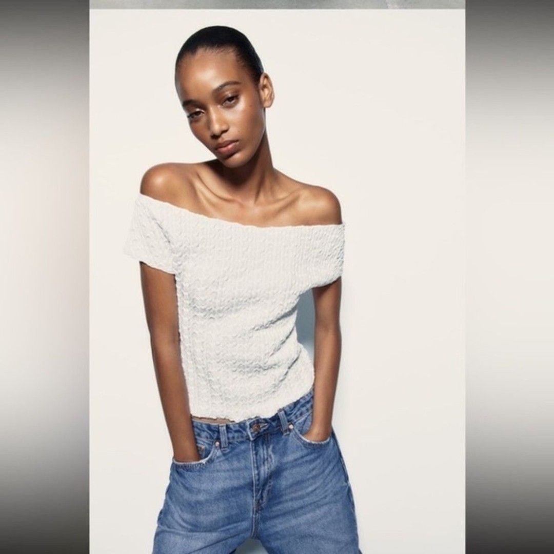 Zara White Off-Shoulder Textured Top (Category: Blouses) located in Taguig. Submitted by ashie_clothing (Listing ID 1467835925, Image 1). Description: - Brand: Zara - Style: Off-shoulder top with short sleeves and raw edges - Color: White - Size: L - Condition: Brand new with original tags attached, never worn - Material: Textured fabric.