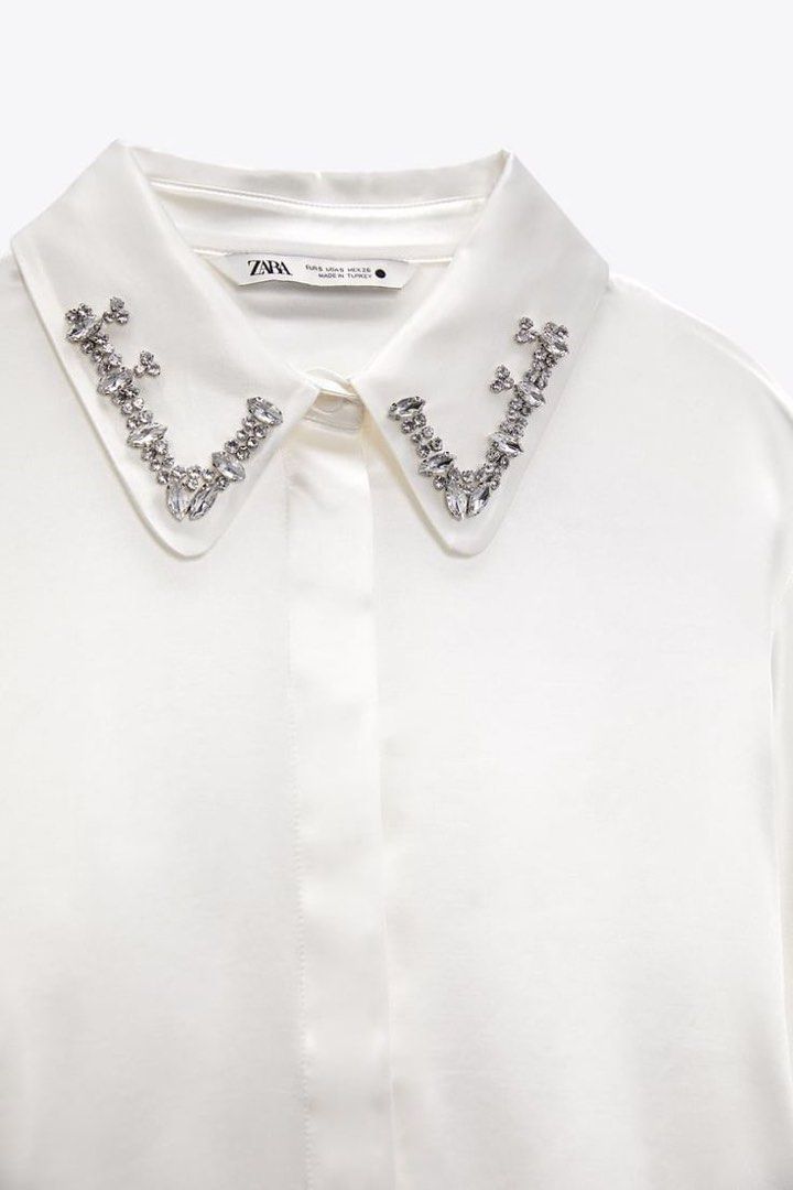 Zara White Satin Long Sleeves (Category: Longsleeves) located in San Juan City. Submitted by kassyjsn (Listing ID 1467783344, Image 1). Description: - Brand: Zara - Item: White Satin Long Sleeves - Size: Small (EU 36 / UK 8 / US 4) - Features: Elegant rhinestone/crystal embellishments on the collar - Perfect for office wear, formal events, or smart-casual outfits Already used. Selling low. Please manage expectations :).