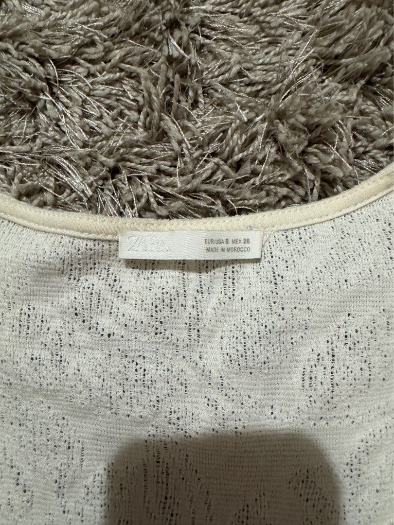 Zara White Textured Ruffle Collar Blouse Size S (Category: Blouses) located in Caloocan City. Submitted by newcrystal_3b43ba (Listing ID 1467739078, Image 2). Description: - Brand: Zara - Size: S - Color: White with textured floral pattern - Details: Short flutter sleeves, large ruffled collar, and peplum hem - Origin: Made in Morocco - Condition: Excellent, clean with no stains or damage.
