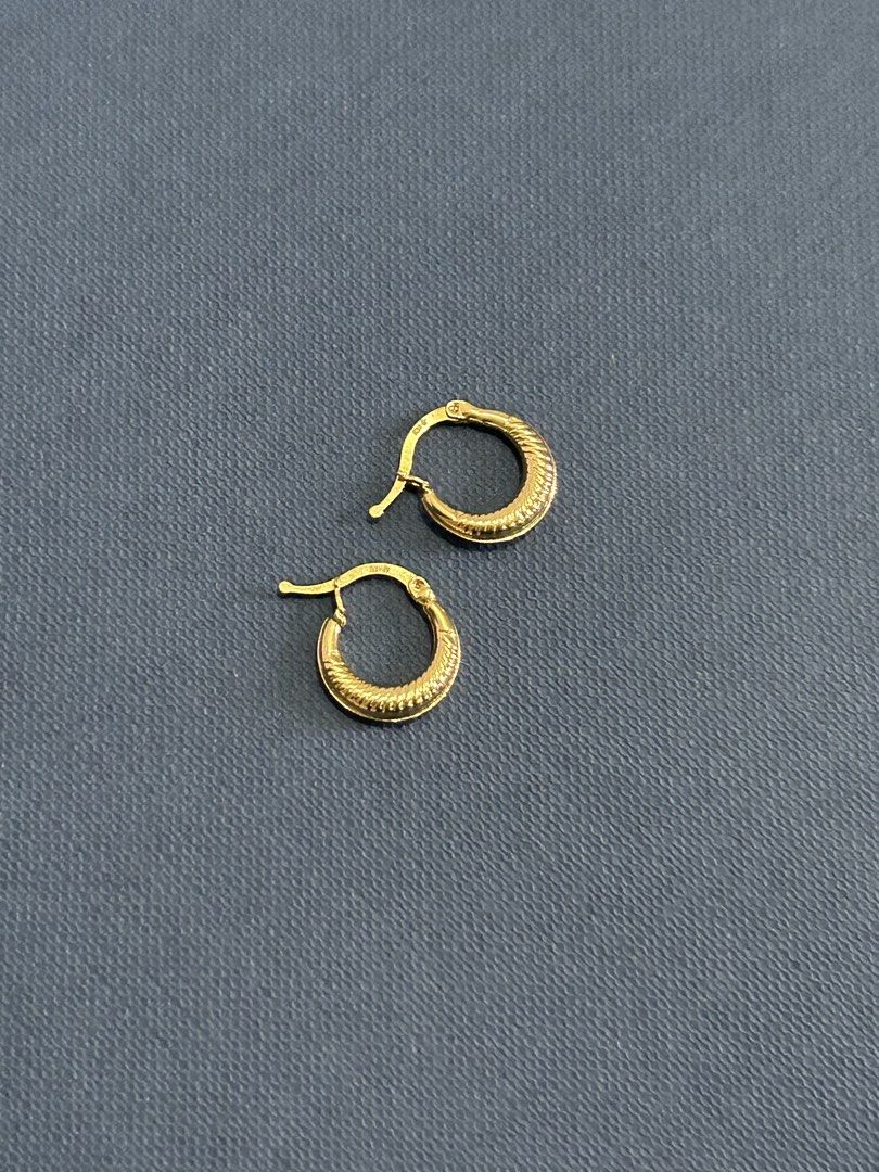 18k gold earrings (Category: Earrings) located in Quezon City. Submitted by celine_25 (Listing ID 1467881188, Image 3). Description: - Small gold huggie hoop earrings - Stylish textured ribbed pattern on the lower half - Secure latch closure for all-day comfort - Polished finish that catches the light - Lightweight design perfect for daily wear - Classic staple piece that matches any outfit - Cleaned and ready for a new home.