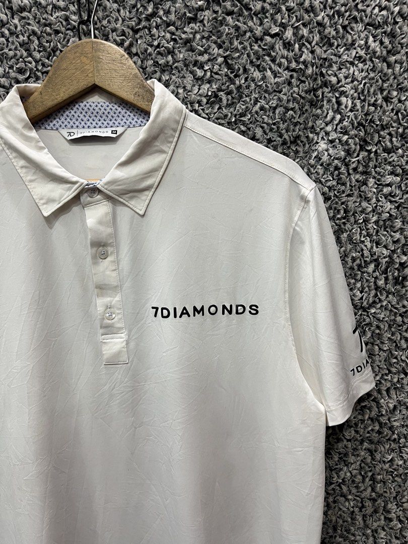 7Diamonds white performance golf polo | Size M (Category: Tshirts & Polo Shirts ) located in General Trias. Submitted by zrchustle.604 (Listing ID 1468055721, Image 2). Description: 7Diamonds white performance golf polo from 7Diamonds, featuring a classic short-sleeve structure, text branding across the left chest, and a patterned detail along the inner collar lining. Known for engineering premium apparel, the brand specializes in 4-way stretch f