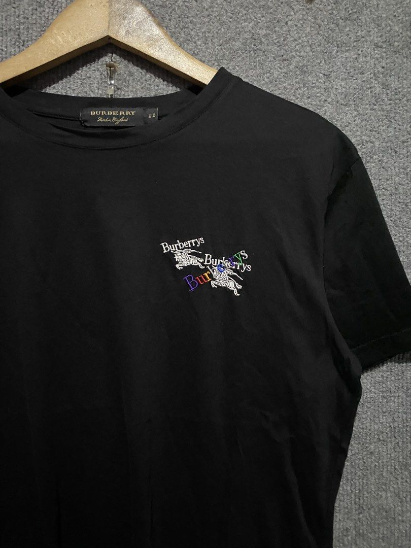 🔥 Authentic Burberry Rainbow Multi-Logo Embroidered Tee (Core Black) (Category: Activewear) located in Tapaz. Submitted by espoting (Listing ID 1467967270, Image 2). Description: Up for grabs is this incredibly clean and premium Burberry Rainbow Prorsum Knight Logo T-Shirt in solid black. Features a high-density, multi-layered embroidery on the chest showcasing the iconic equestrian knight graphic mixed with vibrant, colorful vintage “Burberrys”