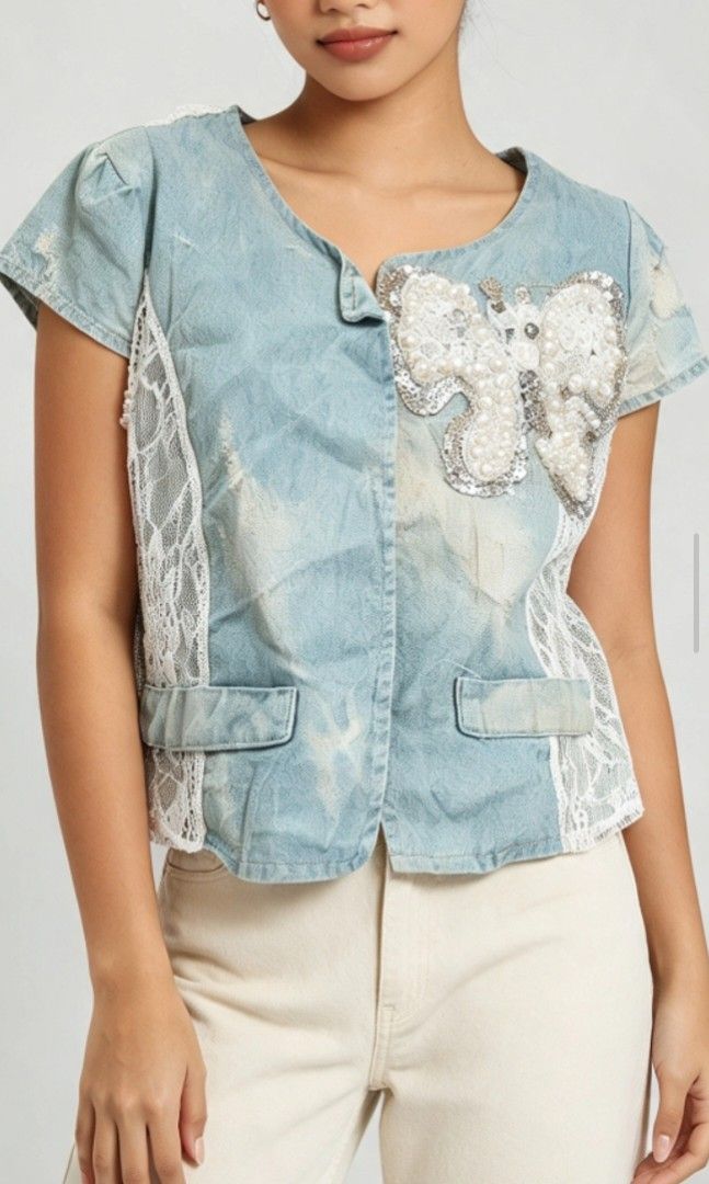 🦋 Y2K Denim & Lace Bow Vest ✨ (Category: Blouses) located in Kalibo. Submitted by cloth.ly (Listing ID 1467851846, Image 1). Description: Measurements: • Pit to Pit: 30" • Length: 15" • Shoulder Width: 13" Details: • Light-wash denim with sheer floral lace sides & back • Beautiful pearl & sequin butterfly appliqué at front 🦋 • Lace back with denim bow detail — so pretty from behind! • Short cap sleeves • Open front style • True Y2K vintage vibe