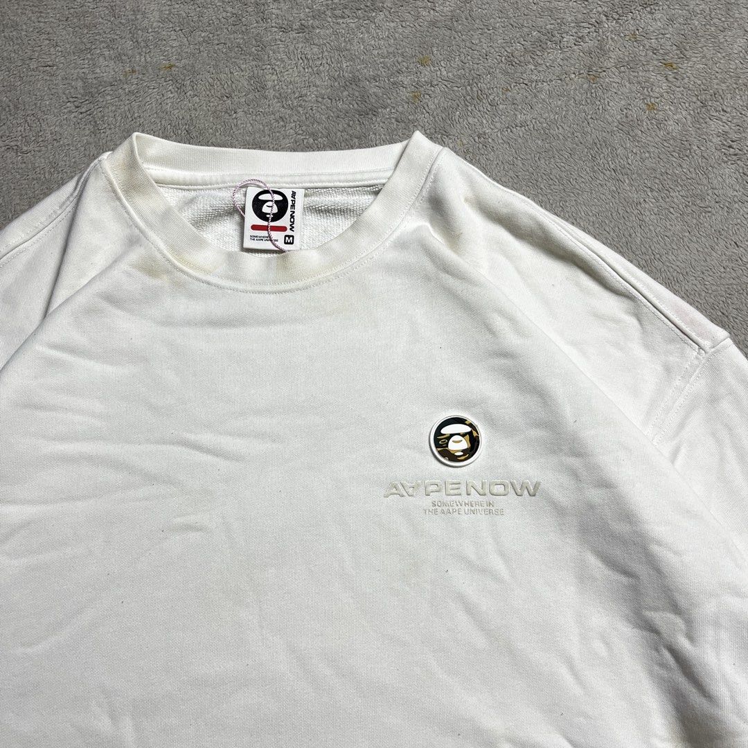 AAPE NOW White Sweatshirt Size M (Category: Coats, Jackets and Outerwear) located in Manila. Submitted by thrifted4life (Listing ID 1467983618, Image 2). Description: AAPE BY *A BATHING APE® crewneck Size M - W:21.5 L:26 Excellent Condition 9.5/10 Light stain .