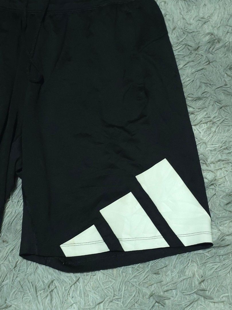 Adidas Black Athletic Shorts with Large Side Logo (Category: Shorts) located in Abulug. Submitted by humanwhosellthings (Listing ID 1467993904, Image 2). Description: - Authentic Adidas athletic shorts ✅Excellent Condition ✅Issue: minimal hairline ▫️Waist Size: 32-40 ▫️Length: 18 - Color: Black with striking white 3-stripe graphic on the right leg and logo on the left - Features secure zippered side pockets to keep your essentials safe - Adjustab