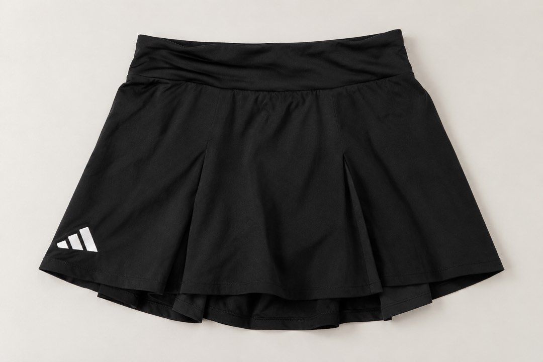 Adidas Black Athletic Skort with White Logo (Category: Activewear) located in Valencia. Submitted by bruuuuh (Listing ID 1467893259, Image 1). Description: - Authentic Adidas athletic skirt in classic black - Built-in shorts underneath for worry-free movement - Flattering pleated front design with a sporty yet classic look - Comfortable wide elastic waistband for a secure fit - Lightweight and breathable fabric ideal for tennis, golf, or running 